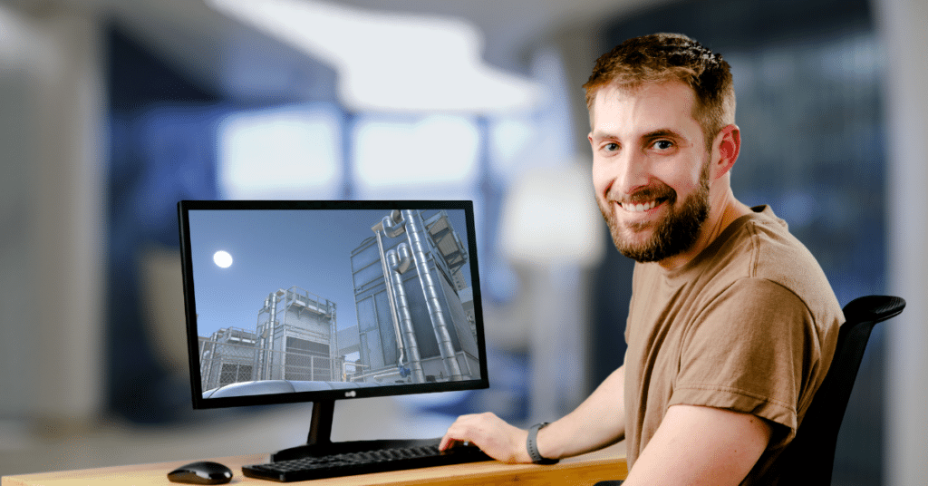 A Man Sitting at a Desk in Front of a Computer Doing Hvac Simulation Training