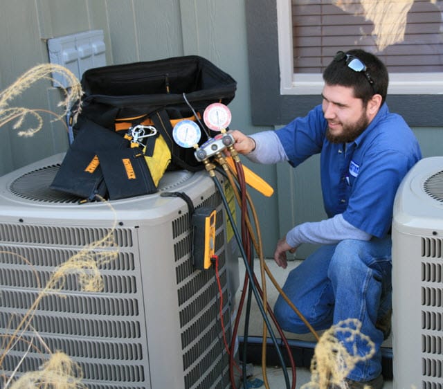 Man working on a HVAC unit, illustrating hands-on training in the Skilled Trades Workforce Development Learning Pathways